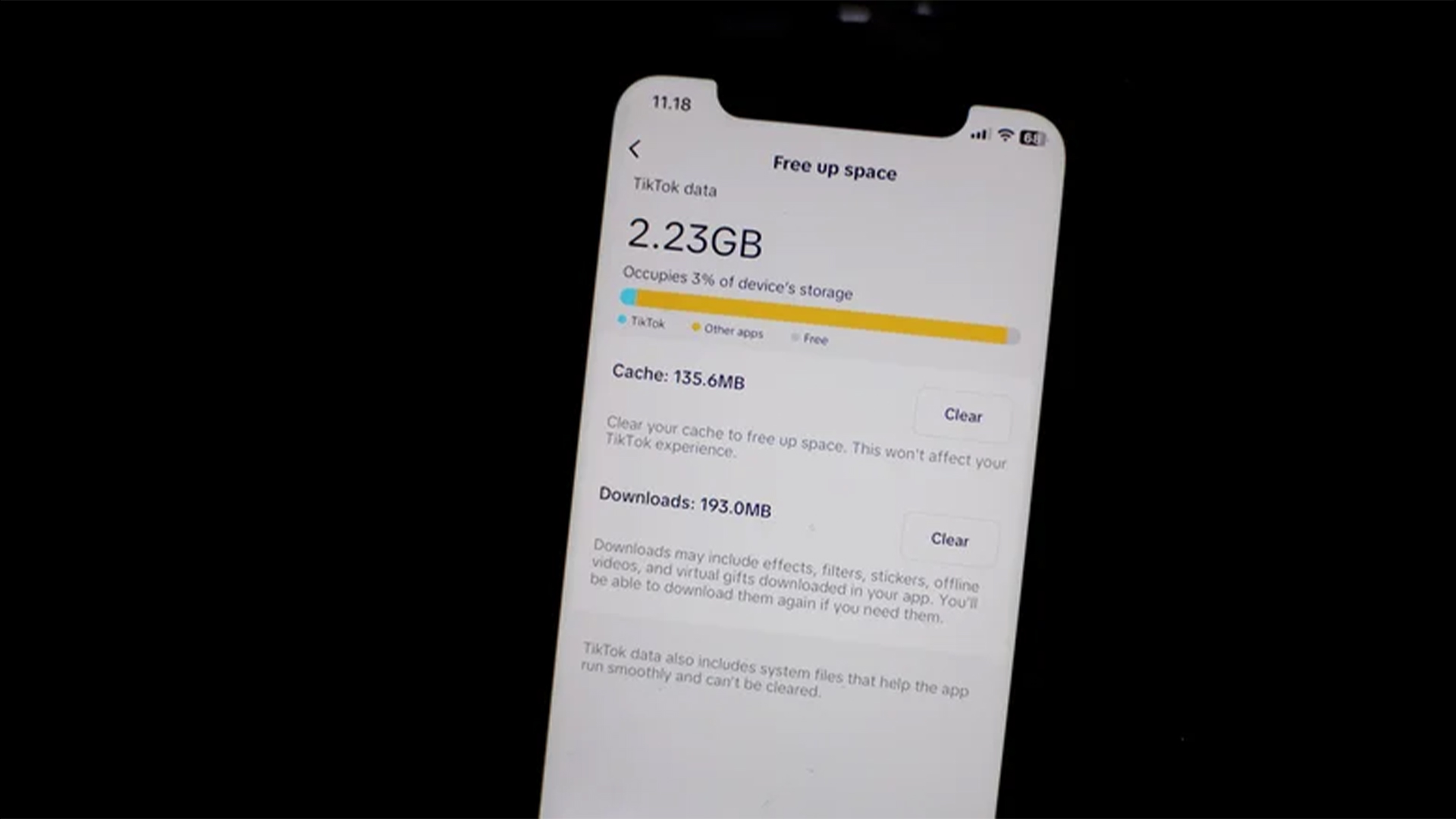 Smartphone screen displaying the TikTok "Free up space" menu, showing 2.23GB of data usage and options to clear the cache or downloads.