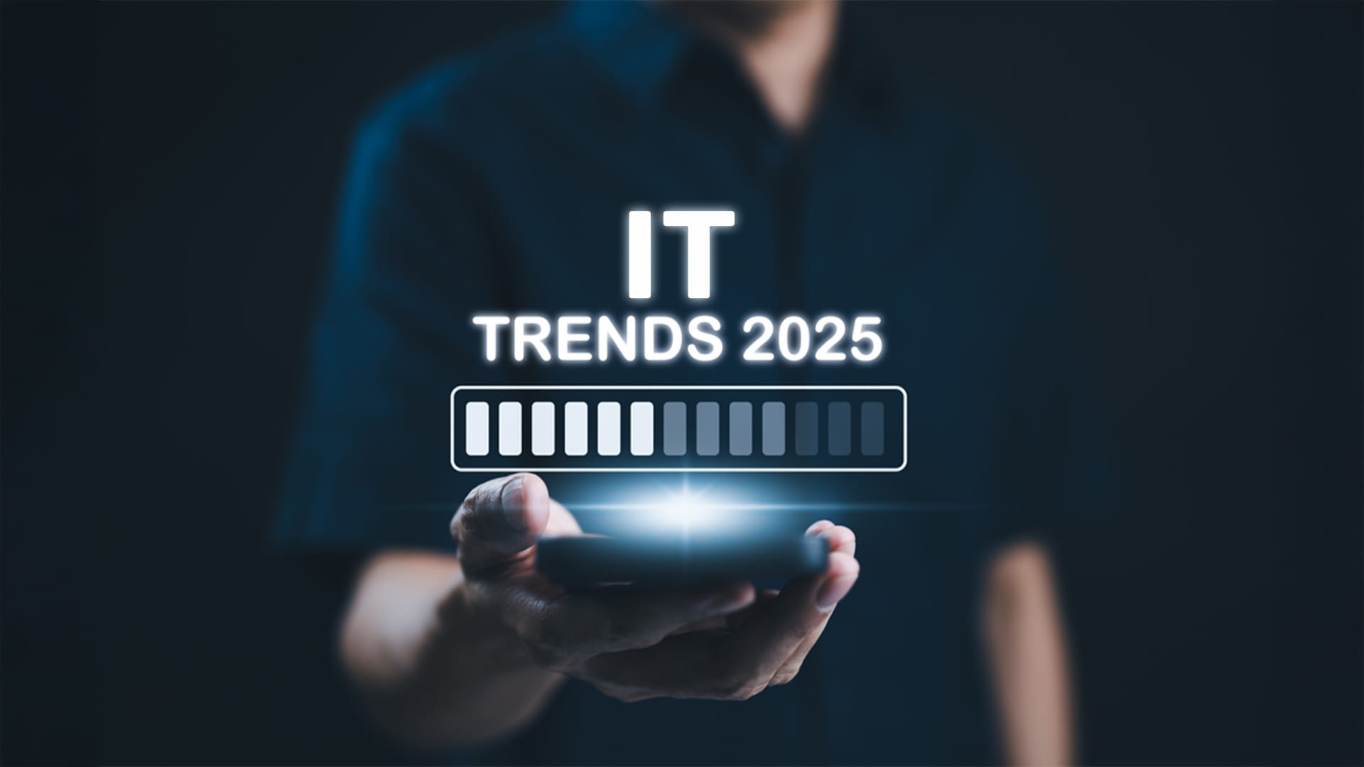 Person holding a hologram with text "IT TRENDS 2025" above their palm, suggesting that IT trends are rapidly evolving and that businesses need to stay up-to-date.